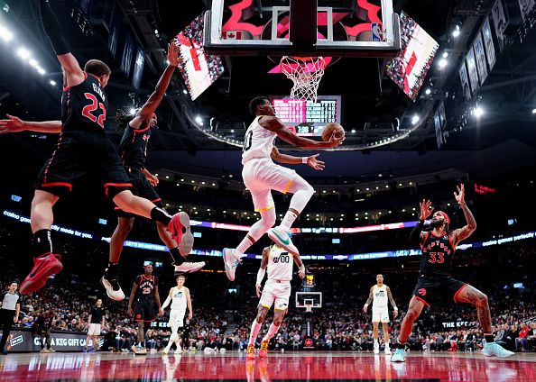 TORONTO, ON - DECEMBER 23: Ochai Agbaji #30 of the Utah Jazz goes to the basket against the Toronto Raptors during the first half of their basketball game at the Scotiabank Arena on December 23, 2023 in Toronto, Ontario, Canada. NOTE TO USER: User expressly acknowledges and agrees that, by downloading and/or using this Photograph, user is consenting to the terms and conditions of the Getty Images License Agreement. (Photo by Mark Blinch/Getty Images)