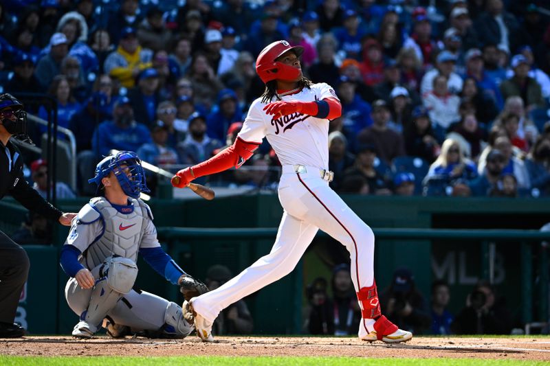 Apr 9, 2025; Washington, District of Columbia, USA; Washington Nationals shortstop CJ Abrams (5) hits a solo home run against the Los Angeles Dodgers during the first inning at Nationals Park. Mandatory Credit: Brad Mills-Imagn Images