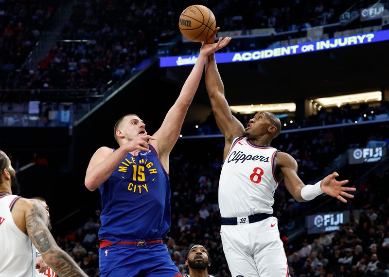 INGLEWOOD, CALIFORNIA - DECEMBER 01:  Kris Dunn #8 of the LA Clippers blocks the shot of Nikola Jokic #15 of the Denver Nuggets in the second half at Intuit Dome on December 01, 2024 in Inglewood, California.  NOTE TO USER: User expressly acknowledges and agrees that, by downloading and or using this photograph, User is consenting to the terms and conditions of the Getty Images License Agreement. (Photo by Ronald Martinez/Getty Images)