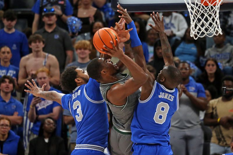 Mar 3, 2024; Memphis, Tennessee, USA; UAB Blazers forward Javian Davis (0) shoots between Memphis Tigers center Jordan Brown (3) and forward David Jones (8) during the first half at FedExForum. Mandatory Credit: Petre Thomas-USA TODAY Sports