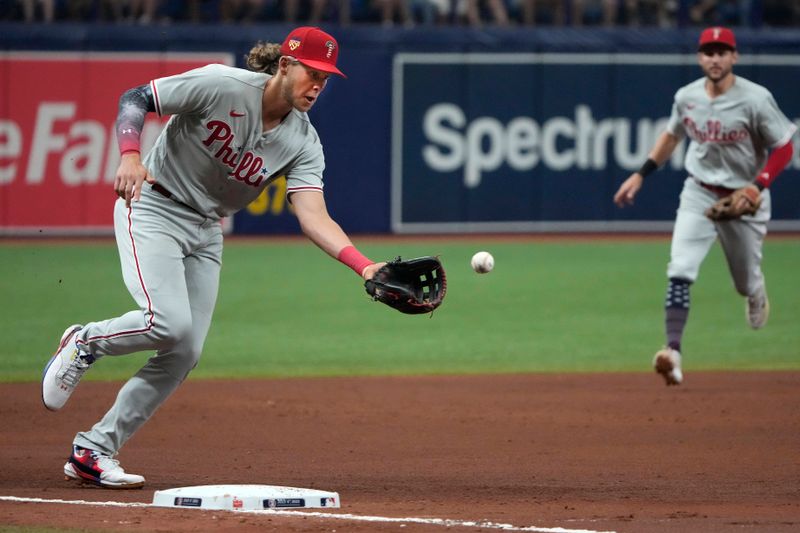 Jul 4, 2023; St. Petersburg, Florida, USA; Philadelphia Phillies third baseman Alec Bohm (28) fields a ball hit by Tampa Bay Rays left fielder Randy Arozarena (not shown) during the sixth inning at Tropicana Field. Mandatory Credit: Dave Nelson-USA TODAY Sports