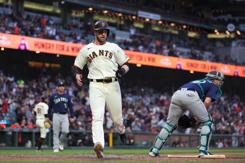 Jul 5, 2023; San Francisco, California, USA; San Francisco Giants center fielder Austin Slater (13) scores a run during the fifth inning against the Seattle Mariners at Oracle Park. Mandatory Credit: Sergio Estrada-USA TODAY Sports