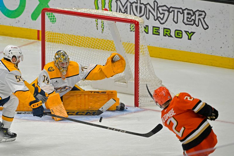 Jan 25, 2025; Anaheim, California, USA; Nashville Predators goaltender Juuse Saros (74) defends a shot on goal by Anaheim Ducks defenseman Jackson LaCombe (2) in the third period at Honda Center. Mandatory Credit: Jayne Kamin-Oncea-Imagn Images