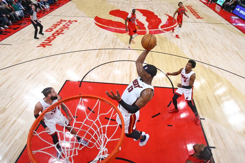 TORONTO, CANADA - JANUARY 17: Bam Adebayo #13 of the Miami Heat rebounds the ball during the game against the Toronto Raptors on January 17, 2024 at the Scotiabank Arena in Toronto, Ontario, Canada.  NOTE TO USER: User expressly acknowledges and agrees that, by downloading and or using this Photograph, user is consenting to the terms and conditions of the Getty Images License Agreement.  Mandatory Copyright Notice: Copyright 2024 NBAE (Photo by Vaughn Ridley/NBAE via Getty Images)