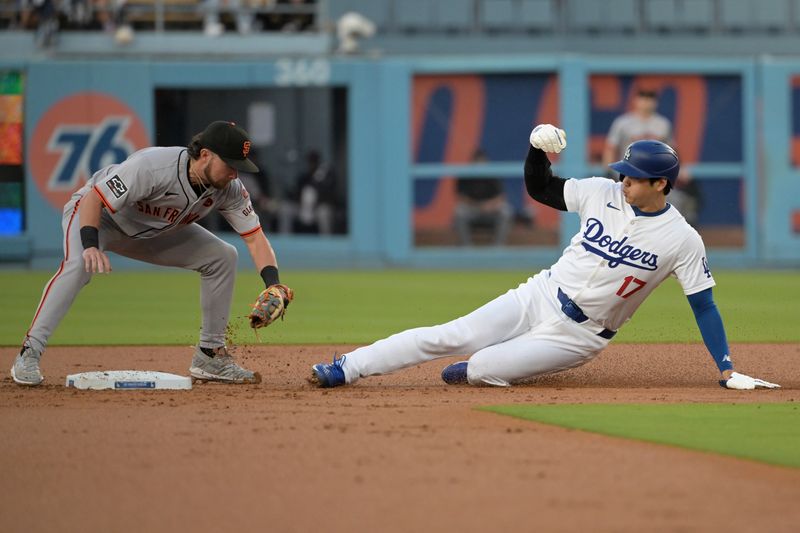 Jul 22, 2024; Los Angeles, California, USA;  Los Angeles Dodgers designated hitter Shohei Ohtani (17) is caught stealing on a tag by San Francisco Giants shortstop Brett Wisely (0) in the first inning at Dodger Stadium. Mandatory Credit: Jayne Kamin-Oncea-USA TODAY Sports