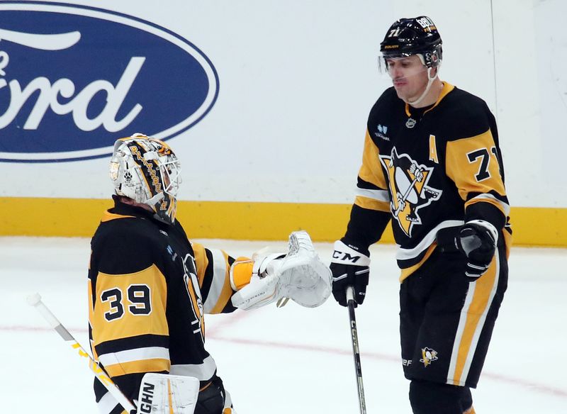 Nov 16, 2024; Pittsburgh, Pennsylvania, USA;  Pittsburgh Penguins goaltender Alex Nedeljkovic (39) and center Evgeni Malkin (71) celebrate after a shootout victory over the San Jose Sharks at PPG Paints Arena. Mandatory Credit: Charles LeClaire-Imagn Images