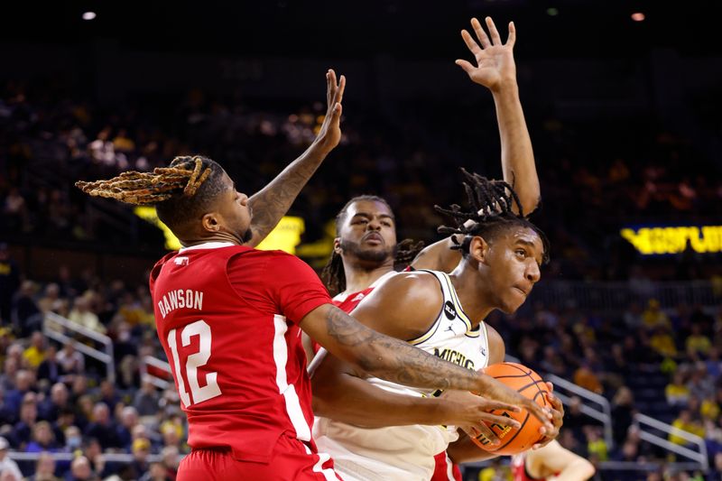 Feb 8, 2023; Ann Arbor, Michigan, USA;  aMichigan Wolverines forward Tarris Reed Jr. (32) is defended by Nebraska Cornhuskers forward Derrick Walker (13) and guard Denim Dawson (12) in the first half t Crisler Center. Mandatory Credit: Rick Osentoski-USA TODAY Sports