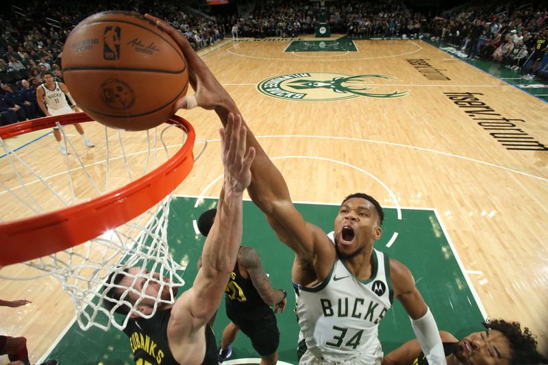 MILWAUKEE, WI - NOVEMBER 7: Giannis Antetokounmpo #34 of the Milwaukee Bucks dunks the ball during the game against the Utah Jazz on November 7, 2024 at Fiserv Forum Center in Milwaukee, Wisconsin. NOTE TO USER: User expressly acknowledges and agrees that, by downloading and or using this Photograph, user is consenting to the terms and conditions of the Getty Images License Agreement. Mandatory Copyright Notice: Copyright 2024 NBAE (Photo by Gary Dineen/NBAE via Getty Images).