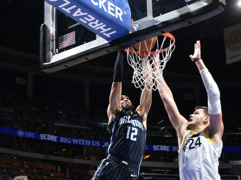 ORLANDO, FL - JANUARY 5 :  Trevelin Queen #12 of the Orlando Magic dunks the ball during the gameagainst the Utah Jazz on January 5, 2025 at Kia Center in Orlando, Florida. NOTE TO USER: User expressly acknowledges and agrees that, by downloading and or using this photograph, User is consenting to the terms and conditions of the Getty Images License Agreement. Mandatory Copyright Notice: Copyright 2025 NBAE (Photo by Fernando Medina/NBAE via Getty Images)