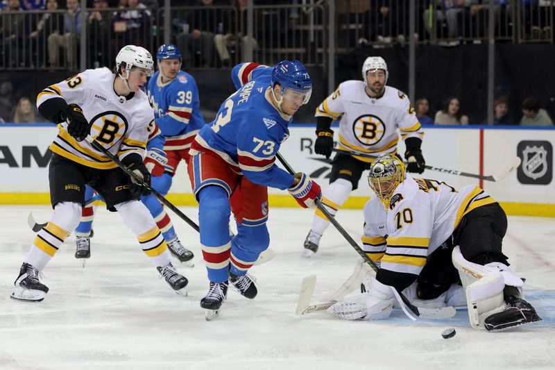 Jan 26, 2026; New York, New York, USA; New York Rangers center Matt Rempe (73) takes a shot against Boston Bruins goaltender Joonas Korpisalo (70) and center Fraser Minten (93) during the second period at Madison Square Garden. Mandatory Credit: Brad Penner-Imagn Images