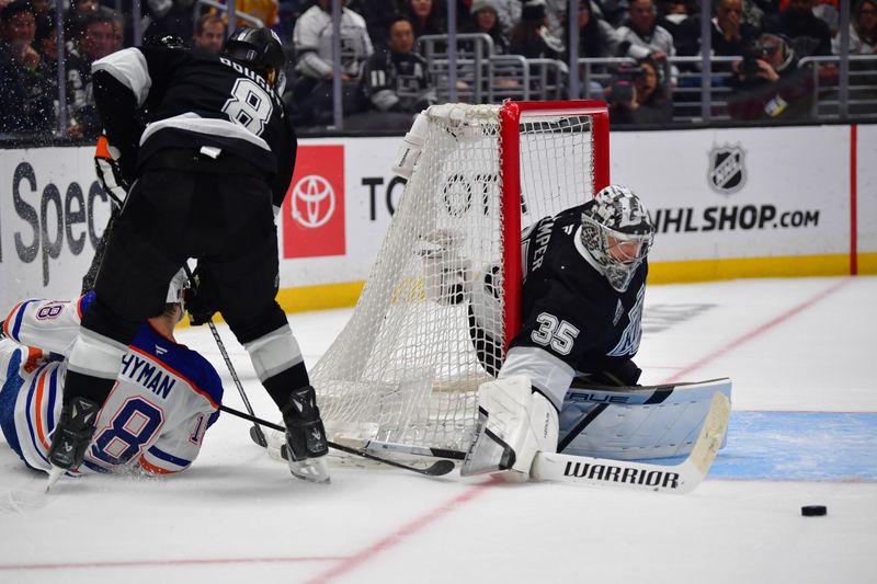 Apr 29, 2025; Los Angeles, California, USA; Los Angeles Kings goaltender Darcy Kuemper (35) blocks a shot against the Edmonton Oilers during the third period in game five of the first round of the 2025 Stanley Cup Playoffs at Crypto.com Arena. Mandatory Credit: Gary A. Vasquez-Imagn Images
