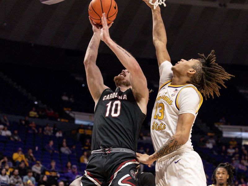 Feb 18, 2023; Baton Rouge, Louisiana, USA; South Carolina Gamecocks forward Hayden Brown (10) drives to the basket against LSU Tigers forward Jalen Reed (13) during the second half at Pete Maravich Assembly Center. Mandatory Credit: Stephen Lew-USA TODAY Sports