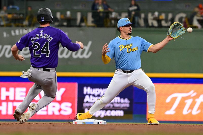 Sep 6, 2024; Milwaukee, Wisconsin, USA; Milwaukee Brewers shortstop Willy Adames (27) forces out Colorado Rockies third baseman Ryan McMahon (24) in the first inning at American Family Field. Mandatory Credit: Benny Sieu-Imagn Images