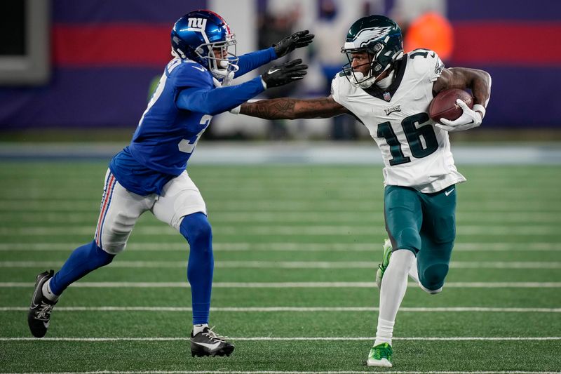 Philadelphia Eagles wide receiver Quez Watkins (16) is tackled by New York Giants cornerback Tre Hawkins III (37) during an NFL football game, Sunday, Jan. 8, 2024, in East Rutherford, N.J. (AP Photo/Bryan Woolston)