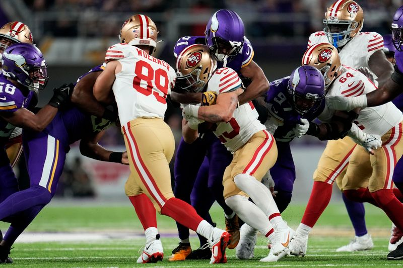 San Francisco 49ers running back Christian McCaffrey (23) is tackled by Minnesota Vikings cornerback Akayleb Evans (21) during the first half of an NFL football game, Monday, Oct. 23, 2023, in Minneapolis. (AP Photo/Abbie Parr)