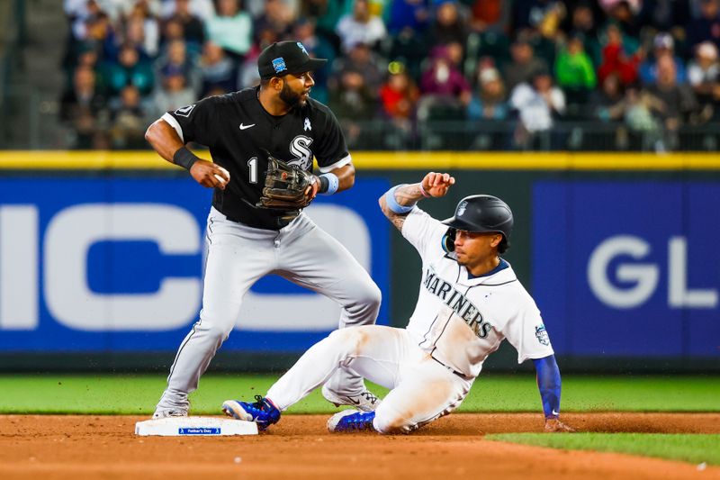 Jun 18, 2023; Seattle, Washington, USA; Chicago White Sox shortstop Elvis Andrus (1) throws to first base for a double play attempt after getting a forecourt of Seattle Mariners second baseman Kolten Wong (right) during the eighth inning at T-Mobile Park. Mandatory Credit: Joe Nicholson-USA TODAY Sports