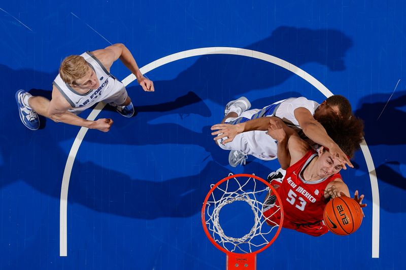 Feb 10, 2023; Colorado Springs, Colorado, USA; New Mexico Lobos forward Josiah Allick (53) drives to the net against Air Force Falcons guard Corbin Green (15) as forward Rytis Petraitis (31) defends in the first half at Clune Arena. Mandatory Credit: Isaiah J. Downing-USA TODAY Sports