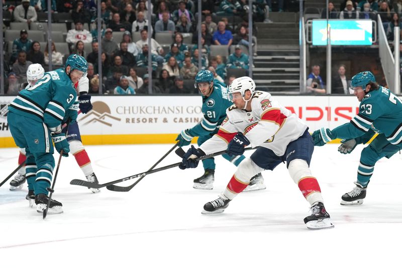 Nov 8, 2025; San Jose, California, USA; Florida Panthers center Sam Reinhart (13) shoots against San Jose Sharks defenseman John Klingberg (3) and center Tyler Toffoli (73) during the first period at SAP Center at San Jose. Mandatory Credit: Darren Yamashita-Imagn Images
