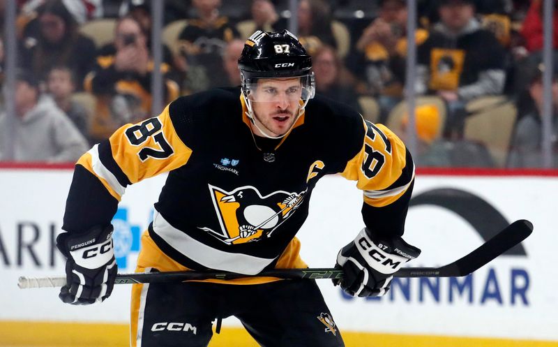 Mar 26, 2024; Pittsburgh, Pennsylvania, USA; Pittsburgh Penguins center Sidney Crosby (87) prepare to take the opening face-off against the Carolina Hurricanes at PPG Paints Arena. Mandatory Credit: Charles LeClaire-USA TODAY Sports