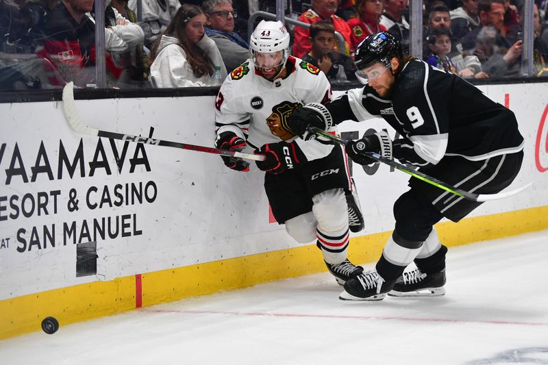 Apr 18, 2024; Los Angeles, California, USA; Los Angeles Kings right wing Adrian Kempe (9) plays for the puck against Chicago Blackhawks center Colin Blackwell (43) during the third period at Crypto.com Arena. Mandatory Credit: Gary A. Vasquez-USA TODAY Sports