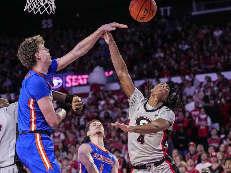 Feb 17, 2024; Athens, Georgia, USA; Georgia Bulldogs guard Silas Demary Jr. (4) has his shot attempt blocked by Florida Gators center Micah Handlogten (3) during the first half at Stegeman Coliseum. Mandatory Credit: Dale Zanine-USA TODAY Sports