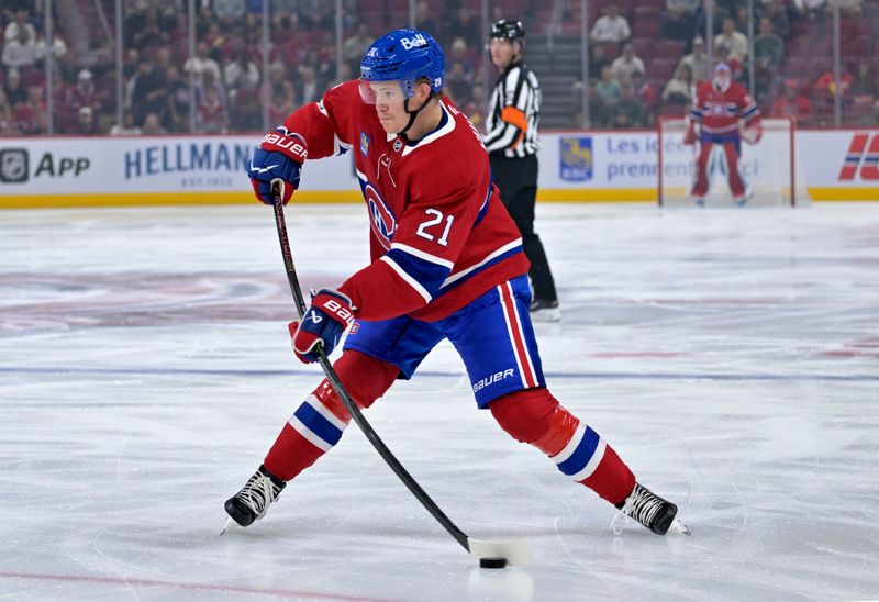 Sep 23, 2025; Montreal, Quebec, CAN; Montreal Canadiens defenseman Kaiden Guhle (21) plays the puck during the first period against the Philadelphia Flyers at the Bell Centre. Mandatory Credit: Eric Bolte-Imagn Images