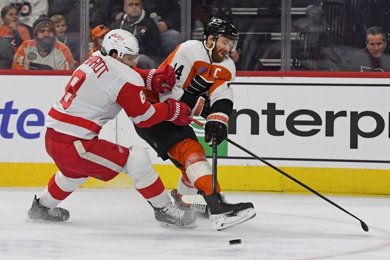 Jan 21, 2025; Philadelphia, Pennsylvania, USA; Philadelphia Flyers center Sean Couturier (14) passes the uck while being defended by Detroit Red Wings defenseman Ben Chiarot (8) during the first period at Wells Fargo Center. Mandatory Credit: Eric Hartline-Imagn Images Jan 21, 2025; Philadelphia, Pennsylvania, USA; Philadelphia Flyers center Sean Couturier (14) passes the uck while being defended by Detroit Red Wings defenseman Ben Chiarot (8) during the first period at Wells Fargo Center. Mandatory Credit: Eric Hartline-Imagn Images