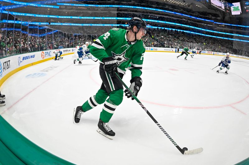 Dec 21, 2023; Dallas, Texas, USA; Dallas Stars center Roope Hintz (24) brings the puck out of the Stars zone during the first period against the Vancouver Canucks at the American Airlines Center. Mandatory Credit: Jerome Miron-USA TODAY Sports