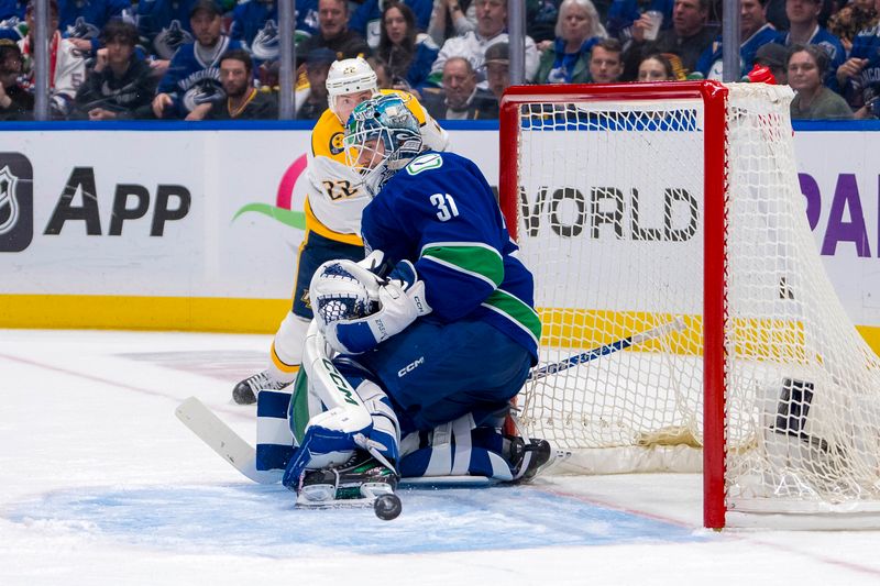 Apr 30, 2024; Vancouver, British Columbia, CAN; Nashville Predators defenseman Tyson Barrie (22) watches his shot go off Vancouver Canucks goalie Arturs Silvos (31) during the second period in game five of the first round of the 2024 Stanley Cup Playoffs at Rogers Arena. Mandatory Credit: Bob Frid-USA TODAY Sports