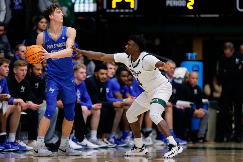 Jan 16, 2024; Fort Collins, Colorado, USA; Air Force Falcons guard Kellan Boylan (23) controls the ball as Colorado State Rams guard Isaiah Stevens (4) guards in the second half at Moby Arena. Mandatory Credit: Isaiah J. Downing-USA TODAY Sports