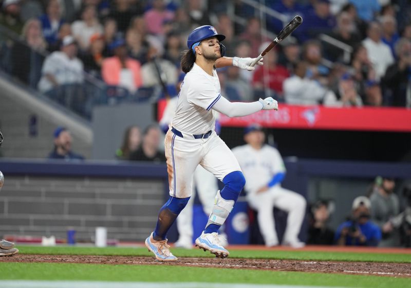 Apr 17, 2024; Toronto, Ontario, CAN; Toronto Blue Jays shortstop Bo Bichette (11) hits a sacrifice scoring a run against the New York Yankees during the seventh inning at Rogers Centre. Mandatory Credit: Nick Turchiaro-USA TODAY Sports