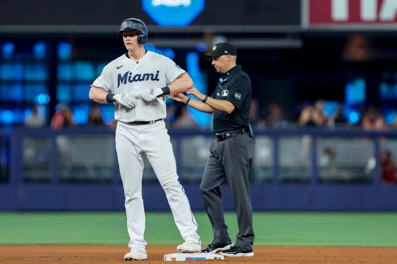 Jun 21, 2023; Miami, Florida, USA; Miami Marlins first baseman Garrett Cooper (26) looks on from second base after hitting a two-run double against the Toronto Blue Jays during the fourth inning at loanDepot Park. Mandatory Credit: Sam Navarro-USA TODAY Sports