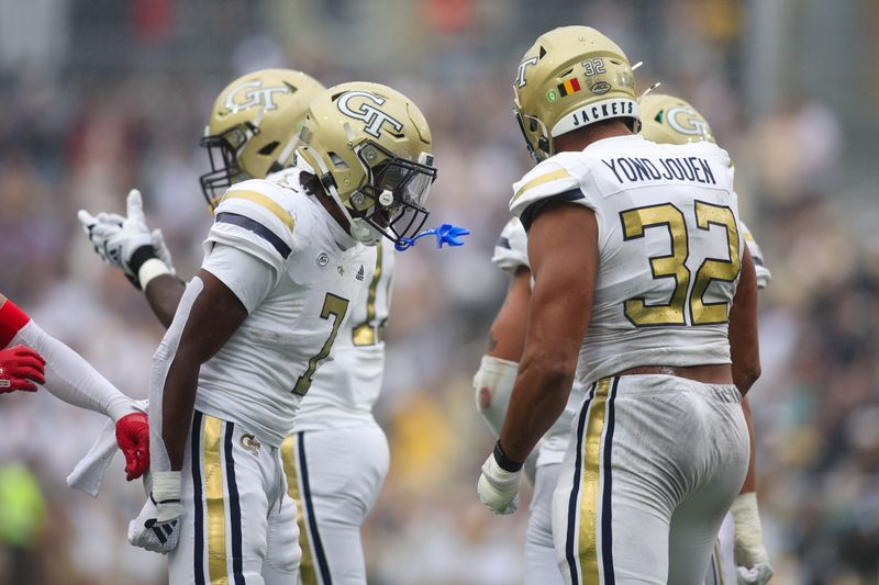 Sep 14, 2024; Atlanta, Georgia, USA; Georgia Tech Yellow Jackets defensive lineman Sylvain Yondjouen (32) celebrates with defensive back Taye Seymore (7) after a sack against the Virginia Military Institute Keydets in the second quarter at Bobby Dodd Stadium at Hyundai Field. Mandatory Credit: Brett Davis-Imagn Images