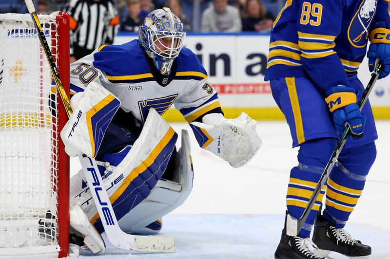 Nov 14, 2024; Buffalo, New York, USA;  St. Louis Blues goaltender Jordan Binnington (50) looks for the puck during the third period against the Buffalo Sabres at KeyBank Center. Mandatory Credit: Timothy T. Ludwig-Imagn Images