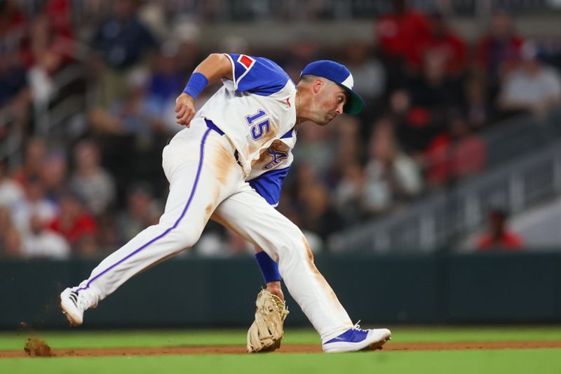 Aug 24, 2024; Atlanta, Georgia, USA; Atlanta Braves second baseman Whit Merrifield (15) fields a ground ball against the Washington Nationals in the ninth inning at Truist Park. Mandatory Credit: Brett Davis-USA TODAY Sports