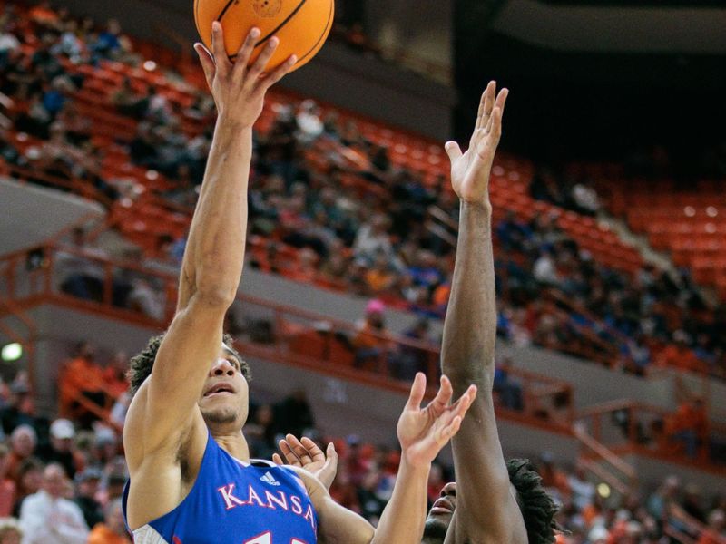 Jan 16, 2024; Stillwater, Oklahoma, USA; Kansas Jayhawks guard Kevin McCullar Jr. (15) puts up a shot over Oklahoma State Cowboys guard Naz Brown (0) during the second half at Gallagher-Iba Arena. Mandatory Credit: William Purnell-USA TODAY Sports