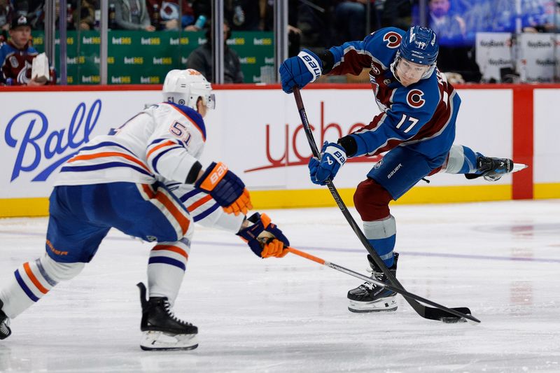 Jan 16, 2025; Denver, Colorado, USA; Colorado Avalanche center Parker Kelly (17) takes a shot as Edmonton Oilers defenseman Troy Stecher (51) defends in the second period at Ball Arena. Mandatory Credit: Isaiah J. Downing-Imagn Images