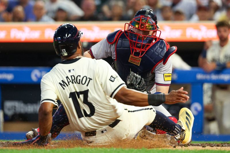 Aug 28, 2024; Minneapolis, Minnesota, USA; Atlanta Braves catcher Sean Murphy (12) tags out Minnesota Twins left fielder Manuel Margot (13) at home plate during the sixth inning at Target Field. Mandatory Credit: Matt Krohn-USA TODAY Sports