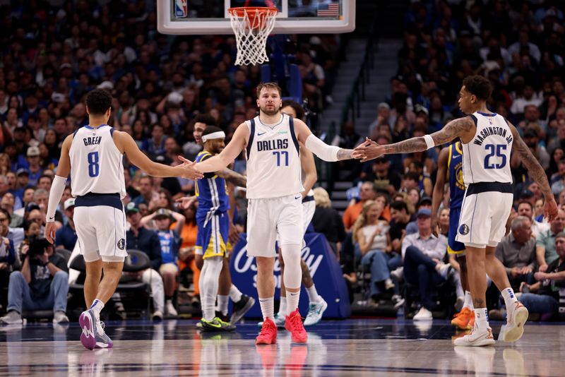 DALLAS, TEXAS - MARCH 13: Luka Doncic #77 of the Dallas Mavericks is congratulated by Josh Green #8 of the Dallas Mavericks and P.J. Washington #25 of the Dallas Mavericks after a basket in the game against the Golden State Warriors at American Airlines Center on March 13, 2024 in Dallas, Texas. NOTE TO USER: User expressly acknowledges and agrees that, by downloading and or using this photograph, User is consenting to the terms and conditions of the Getty Images License Agreement. (Photo by Tim Heitman/Getty Images)