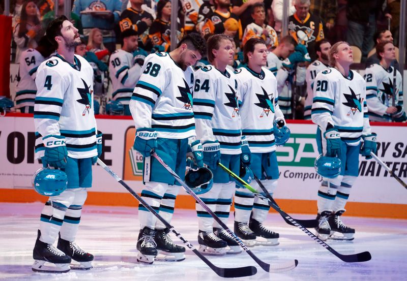 Mar 14, 2024; Pittsburgh, Pennsylvania, USA; The San Jose Sharks starting lineup (L to R) defenseman Kyle Burroughs (4) and defenseman Mario Ferraro (38) and center Mikael Granlund (64) and left wing Alexander Barabanov (94) and right wing Fabian Zetterlund (20) stand for the national anthem against the Pittsburgh Penguins at PPG Paints Arena. Pittsburgh won 6-3. Mandatory Credit: Charles LeClaire-USA TODAY Sports