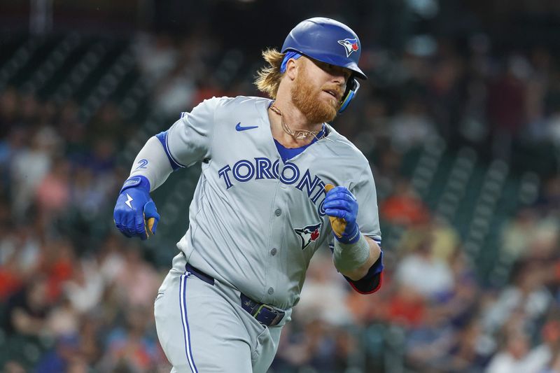 Apr 2, 2024; Houston, Texas, USA; Toronto Blue Jays designated hitter Justin Turner (2) runs to first base on a double during the first inning against the Houston Astros at Minute Maid Park. Mandatory Credit: Troy Taormina-USA TODAY Sports