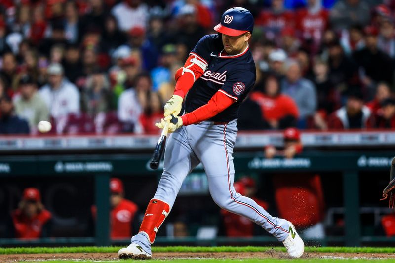 May 3, 2025; Cincinnati, Ohio, USA; Washington Nationals first baseman Nathaniel Lowe (33) hits a RBI single in the sixth inning against the Cincinnati Reds at Great American Ball Park. Mandatory Credit: Katie Stratman-Imagn Images