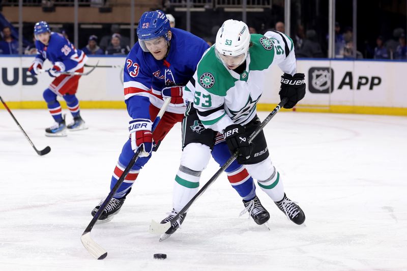 Feb 20, 2024; New York, New York, USA; New York Rangers defenseman Adam Fox (23) fights for the puck against Dallas Stars center Wyatt Johnston (53) during the second period at Madison Square Garden. Mandatory Credit: Brad Penner-USA TODAY Sports