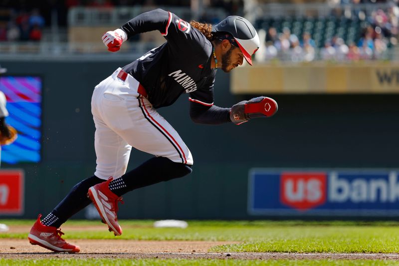 Apr 20, 2024; Minneapolis, Minnesota, USA; Minnesota Twins left fielder Austin Martin (82) tags up from third base and scores against the Detroit Tigers in the third inning on a sacrifice fly by Ryan Jeffers (not pictured) at Target Field. Mandatory Credit: Bruce Kluckhohn-USA TODAY Sports