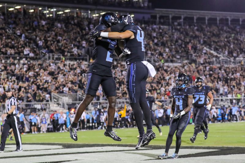 Oct 13, 2022; Orlando, Florida, USA; UCF Knights wide receiver Kobe Hudson (2) celebrates after scoring during the second quarter against the Temple Owls at FBC Mortgage Stadium. Mandatory Credit: Mike Watters-USA TODAY Sports