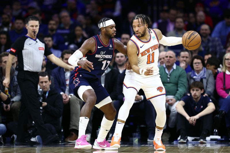 PHILADELPHIA, PENNSYLVANIA - FEBRUARY 22: Buddy Hield #17 of the Philadelphia 76ers guards Jalen Brunson #11 of the New York Knicks during the first quarter at the Wells Fargo Center on February 22, 2024 in Philadelphia, Pennsylvania. (Photo by Tim Nwachukwu/Getty Images)