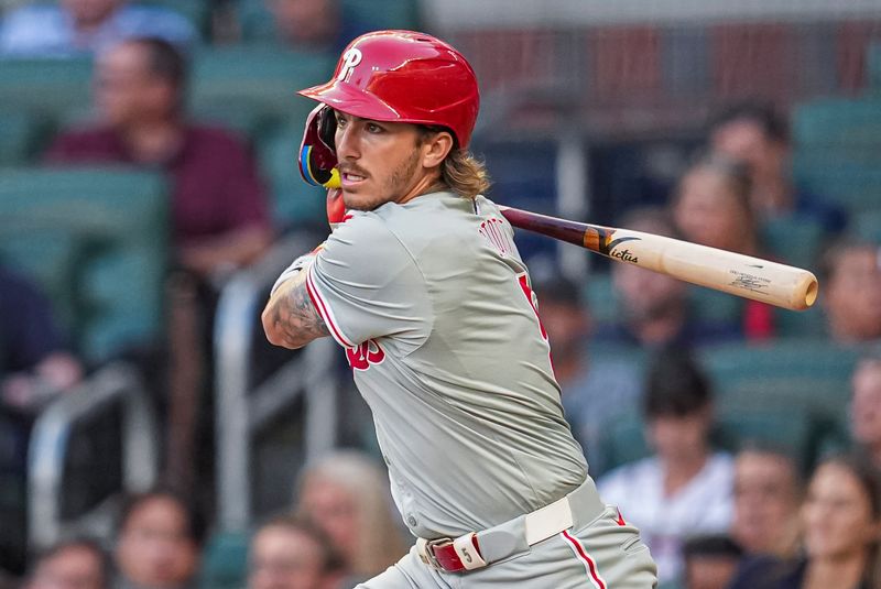 Aug 20, 2024; Cumberland, Georgia, USA; Philadelphia Phillies second baseman Bryson Stott (5) singles against the Atlanta Braves during the second inning at Truist Park. Mandatory Credit: Dale Zanine-USA TODAY Sports