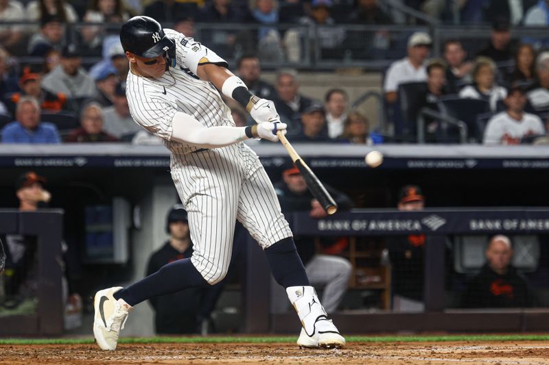 Sep 24, 2024; Bronx, New York, USA; New York Yankees center fielder Aaron Judge (99) hits a solo home run during the fourth inning against the Baltimore Orioles at Yankee Stadium. Mandatory Credit: Vincent Carchietta-Imagn Images