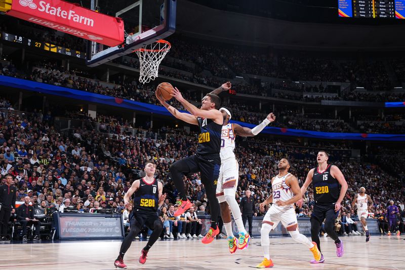 DENVER, CO - MARCH 27: Collin Gillespie #21 of the Denver Nuggets drives to the basket during the game against the Phoenix Suns on March 27, 2023 at the Ball Arena in Denver, Colorado. NOTE TO USER: User expressly acknowledges and agrees that, by downloading and/or using this Photograph, user is consenting to the terms and conditions of the Getty Images License Agreement. Mandatory Copyright Notice: Copyright 2024 NBAE (Photo by Garrett Ellwood/NBAE via Getty Images)