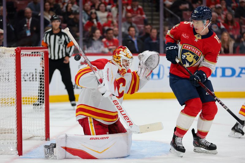Nov 28, 2025; Sunrise, Florida, USA; Calgary Flames center Mikael Backlund (11) makes a save against Florida Panthers center Anton Lundell (15) during the first period at Amerant Bank Arena. Mandatory Credit: Sam Navarro-Imagn Images Nov 28, 2025; Sunrise, Florida, USA; Calgary Flames center Mikael Backlund (11) makes a save against Florida Panthers center Anton Lundell (15) during the first period at Amerant Bank Arena. Mandatory Credit: Sam Navarro-Imagn Images